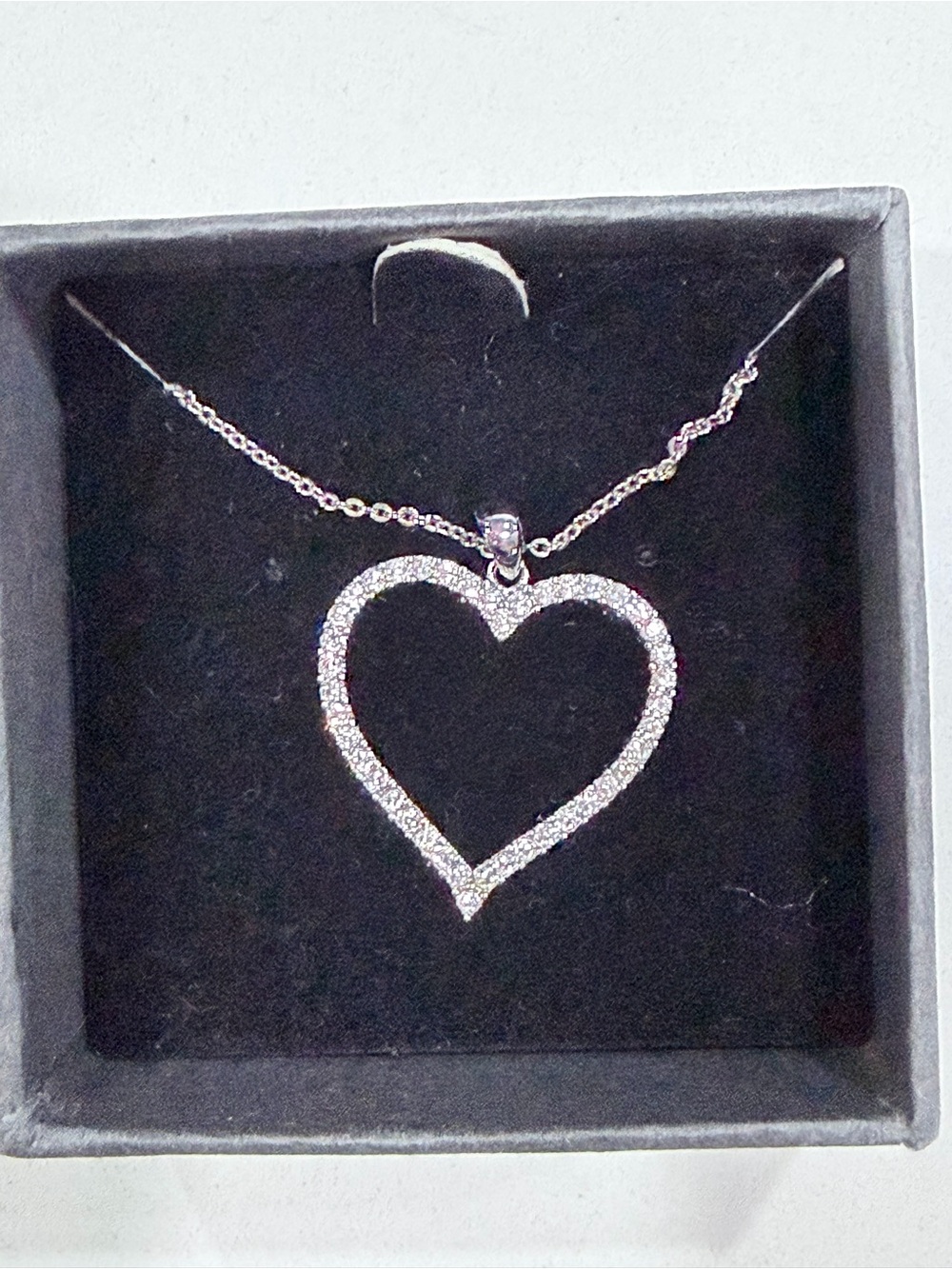 Silver-tone open heart pendant necklace adorned with Swarovski crystals.
